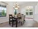 Elegant dining room with large window, chandelier, and carpeted floor at 5605 Killen Ave, Castle Rock, CO 80104