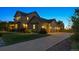 Charming two-story home with a spacious three car garage and well-maintained landscaping at dusk at 5605 Killen Ave, Castle Rock, CO 80104
