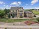 Beautiful two-story home with a large, well-maintained lawn, mature trees and front porch at 5605 Killen Ave, Castle Rock, CO 80104