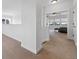 Hallway leading to bedroom, featuring neutral carpet, white trim, and open layout at 5605 Killen Ave, Castle Rock, CO 80104