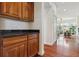 Hallway including wood cabinets and floors with a view to the living room at 5605 Killen Ave, Castle Rock, CO 80104