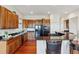 Kitchen boasts dark countertops, wooden cabinets, stainless steel appliances, and hardwood flooring at 5605 Killen Ave, Castle Rock, CO 80104