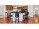 This kitchen features an island with bar seating, wooden cabinets, and hardwood flooring at 5605 Killen Ave, Castle Rock, CO 80104