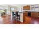 Open-concept kitchen with stainless steel appliances, breakfast bar, and hardwood flooring at 5605 Killen Ave, Castle Rock, CO 80104