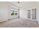 Bright living room with large window, modern doors, and neutral carpet at 5605 Killen Ave, Castle Rock, CO 80104