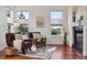 Inviting living room with large windows, a fireplace, and hardwood floors at 5605 Killen Ave, Castle Rock, CO 80104