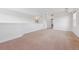 Bright, spacious living area with neutral carpet, white walls, and ample natural light at 5605 Killen Ave, Castle Rock, CO 80104