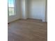 Light filled bedroom with hardwood flooring and a large window at 6739 Juniper Dr, Thornton, CO 80602