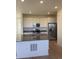 Modern kitchen featuring an island, stainless steel appliances, and white cabinetry at 6739 Juniper Dr, Thornton, CO 80602