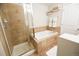 Bathroom featuring a soaking tub, glass shower, and decorative shelves with plush towels at 451 S Reed St, Lakewood, CO 80226