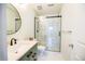 Modern bathroom with glass shower, sleek vanity, tile floor, and modern fixtures at 451 S Reed St, Lakewood, CO 80226