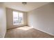 Bright bedroom featuring a large window and neutral carpet, perfect for personalization at 451 S Reed St, Lakewood, CO 80226