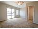Spacious carpeted bedroom with a sliding glass door to exterior deck at 451 S Reed St, Lakewood, CO 80226