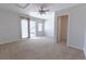 Bright bedroom with a ceiling fan, natural light, neutral carpet, and access to a balcony at 451 S Reed St, Lakewood, CO 80226
