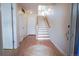 Inviting entryway with hardwood floors, white doors, stairs, and a round rug at 451 S Reed St, Lakewood, CO 80226
