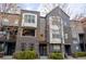 Attractive townhouse exterior featuring gray brick, multiple windows, and small front garden at 451 S Reed St, Lakewood, CO 80226