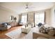 Bright living room featuring a ceiling fan, hardwood floors, lots of seating and natural light at 451 S Reed St, Lakewood, CO 80226