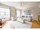 Spacious living room with hardwood floors, ceiling fan, comfortable seating, and lots of light at 451 S Reed St, Lakewood, CO 80226