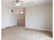 Spacious loft area with carpet flooring, ceiling fan, and access to upper level at 451 S Reed St, Lakewood, CO 80226