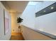 Bright hallway with natural light from skylight, hardwood floors, and minimalist decor at 421 Dexter St, Denver, CO 80220
