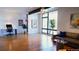 Bright living room featuring hardwood floors, modern decor, and large windows letting in ample natural light at 421 Dexter St, Denver, CO 80220