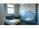Bright room with daybed and bubble chair, with natural light from window at 421 Dexter St, Denver, CO 80220