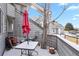 Relaxing outdoor patio with a table, potted plants, and a vibrant pink umbrella for shade at 17054 E Tennessee Dr # 104, Aurora, CO 80017