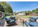 Backyard lawn area featuring a firepit, seating, and spacious grass at 4844 E 110Th Pl, Thornton, CO 80233