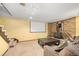 Basement with a movie projector, fireplace, and comfortable seating area at 4844 E 110Th Pl, Thornton, CO 80233