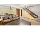 Spacious basement with a comfortable seating area, foosball table, and stairs at 4844 E 110Th Pl, Thornton, CO 80233