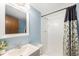 Cozy bathroom featuring a white sink and shower with patterned curtains at 4844 E 110Th Pl, Thornton, CO 80233