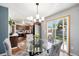 Dining area with stylish chairs and chandelier, connecting to the kitchen and patio at 4844 E 110Th Pl, Thornton, CO 80233