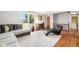 Bright living room with large window, stylish rug, and inviting lounge chair at 4844 E 110Th Pl, Thornton, CO 80233