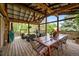 Covered patio boasting a dining area, comfortable seating, and a serene view of the landscaped backyard at 1 Rangeview Dr, Wheat Ridge, CO 80215