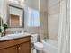 Bright bathroom featuring a granite countertop, wood vanity, and a shower over the bathtub at 4420 White Rock Dr, Broomfield, CO 80023