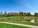 Beautiful community view featuring a pond, lush greenery, and inviting architecture at 4420 White Rock Dr, Broomfield, CO 80023