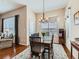 Inviting dining room with a chandelier and views into the living area at 4420 White Rock Dr, Broomfield, CO 80023