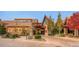 An inviting community building with appealing architecture, lush greenery, and a circular driveway at 4420 White Rock Dr, Broomfield, CO 80023