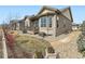 Beautiful home exterior featuring a manicured lawn, stone accents, and a deck at 4420 White Rock Dr, Broomfield, CO 80023