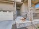 Inviting front porch with stone pillars and a well-manicured front yard enhance this home's curb appeal at 4420 White Rock Dr, Broomfield, CO 80023