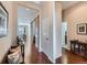Inviting hallway featuring hardwood floors, sliding barn door, and access to various rooms at 4420 White Rock Dr, Broomfield, CO 80023