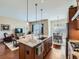 Open-concept kitchen showcasing granite counters, a center island, and seamless flow to the living and dining areas at 4420 White Rock Dr, Broomfield, CO 80023