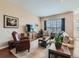 Cozy living room featuring a large window, plush seating, and a neutral color palette at 4420 White Rock Dr, Broomfield, CO 80023