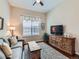 Comfortable living room with a cozy couch, wooden cabinet, and a large window at 4420 White Rock Dr, Broomfield, CO 80023