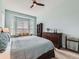Light-filled main bedroom offering large window, a ceiling fan, and comfortable seating area at 4420 White Rock Dr, Broomfield, CO 80023
