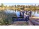 Picturesque pond view with a charming pier and a tranquil bench, perfect for relaxation at 4420 White Rock Dr, Broomfield, CO 80023