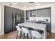 Modern kitchen with gray cabinets, white countertops, and stainless steel appliances at 1750 Wewatta St # 1521, Denver, CO 80202