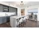 Modern kitchen with gray cabinets, white quartz island, and stainless steel appliances at 1750 Wewatta St # 1521, Denver, CO 80202