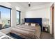 Main bedroom with city views and a luxurious bed at 1750 Wewatta St # 1521, Denver, CO 80202