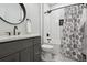 Modern bathroom featuring a tub with a stylish shower curtain and white subway tile at 18079 E 108Th Pl, Commerce City, CO 80022